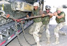 US Navy 030730-N-9455K-103 Seabees use a breaker bar to secure a bulldozer before transporting...jpg US Navy 030730-N-9455K-103 Seabees use a breaker bar to secure a bulldozer before transporting...jpg