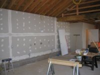 Garage doors installed interior rear wall sheetrocked.JPG
