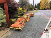 Sandbags on pallets in our parking strip.jpg