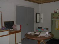 temp living area, dbl doors go to unfinished kit, utility, downstairs.jpg